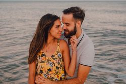 Loving couple embracing happily on sandy beach