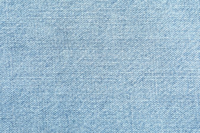 Texture of blue jeans as background, space for text