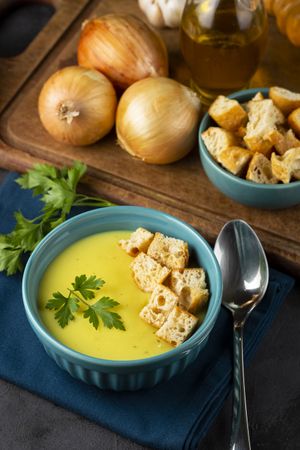 Bowl with onion soup and croutons on the table.