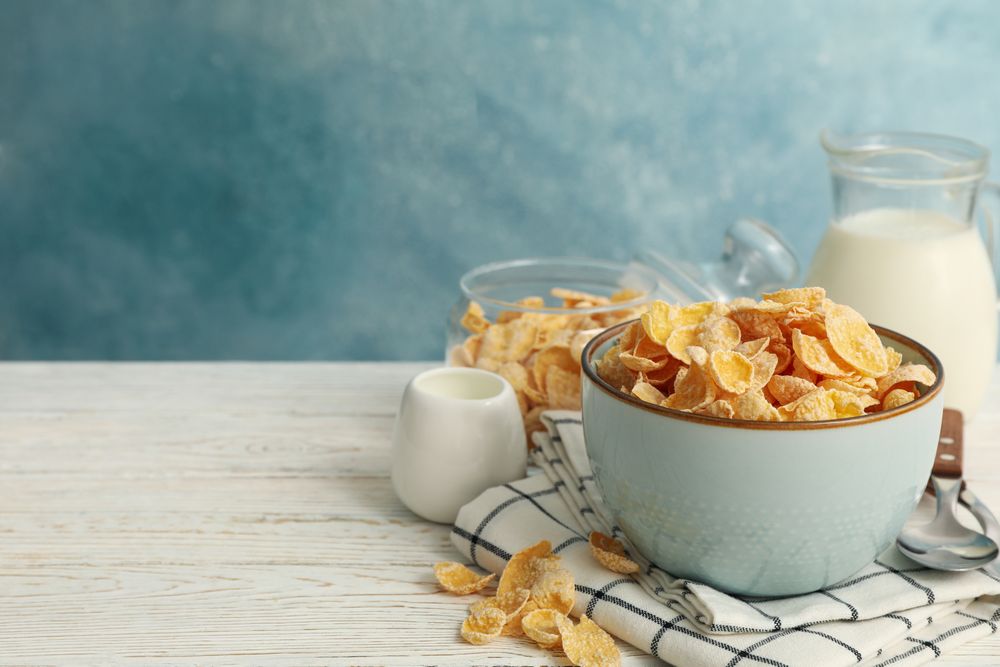 Concept of breakfast with muesli and milk on wooden table