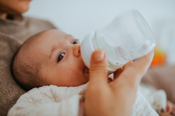 Side view of baby being bottle fed