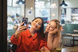 Young women taking selfie in cafe
