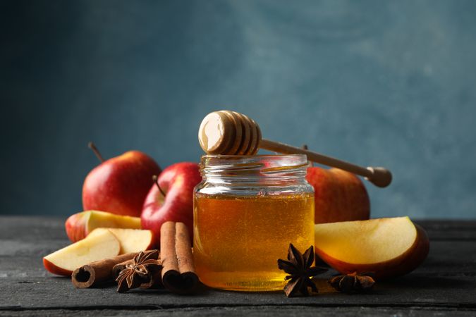 Apples, anise, cinnamon stick honey on table