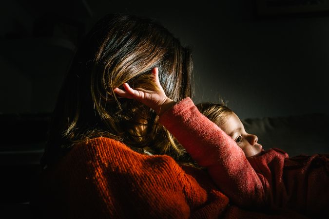 anonymous woman with melancholic daughter