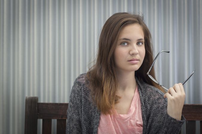 Portrait of Melancholy Young Girl with Glasses
