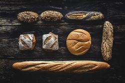 Assorted gold homemade bread on dark wood background