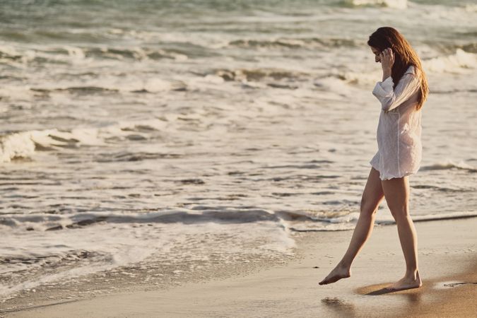 Woman with white dress at the beach