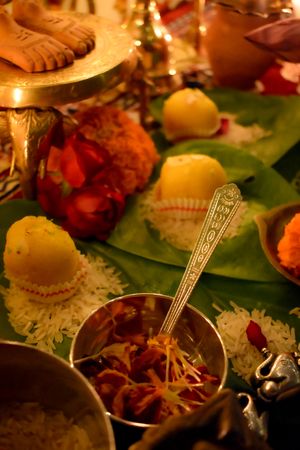 Bowl of food beside Indian desserts
