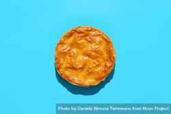 Phyllo dough cake with spinach and cheese, above view on a blue background beZ330