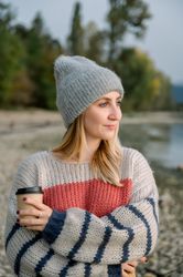 Smiling woman in warm clothes at lake