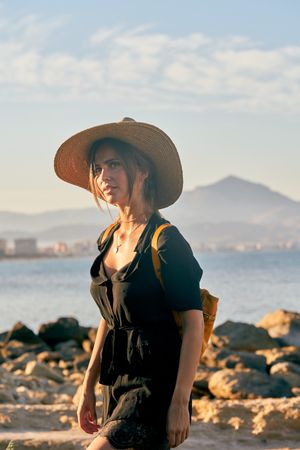 Woman traveler in straw hat walking
