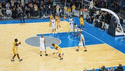 TV Broadcast Style Footage Of Basketball Championship: Yellow Team Passing the Ball, Player Scoring a Goal with a Dunk That Brings the Multicultural Team Closer to Victory.