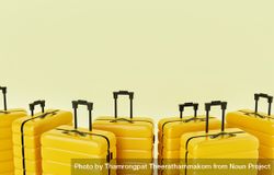 Yellow hard shell roller suitcases in a pastel yellow room 4AQqq4