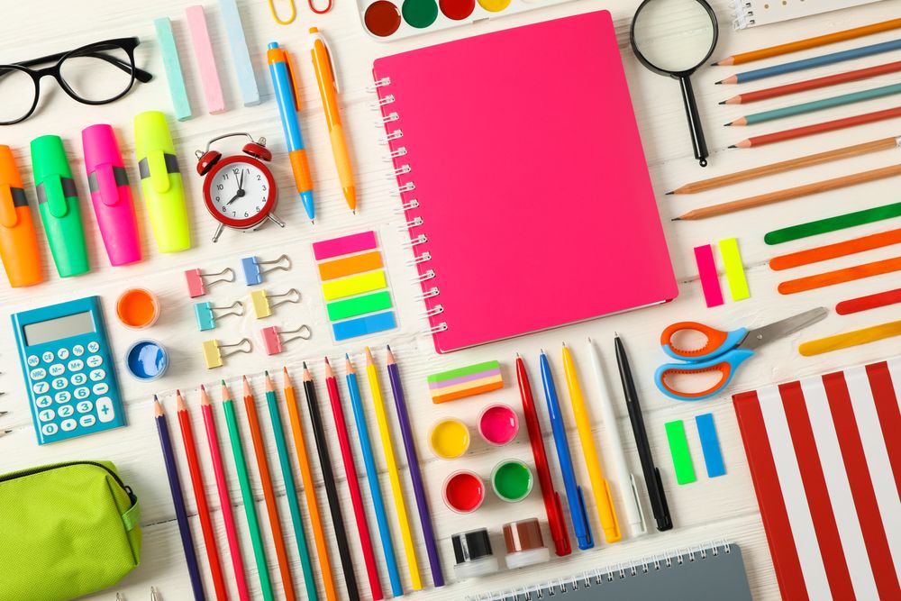Flat lay composition with school supplies on wooden background