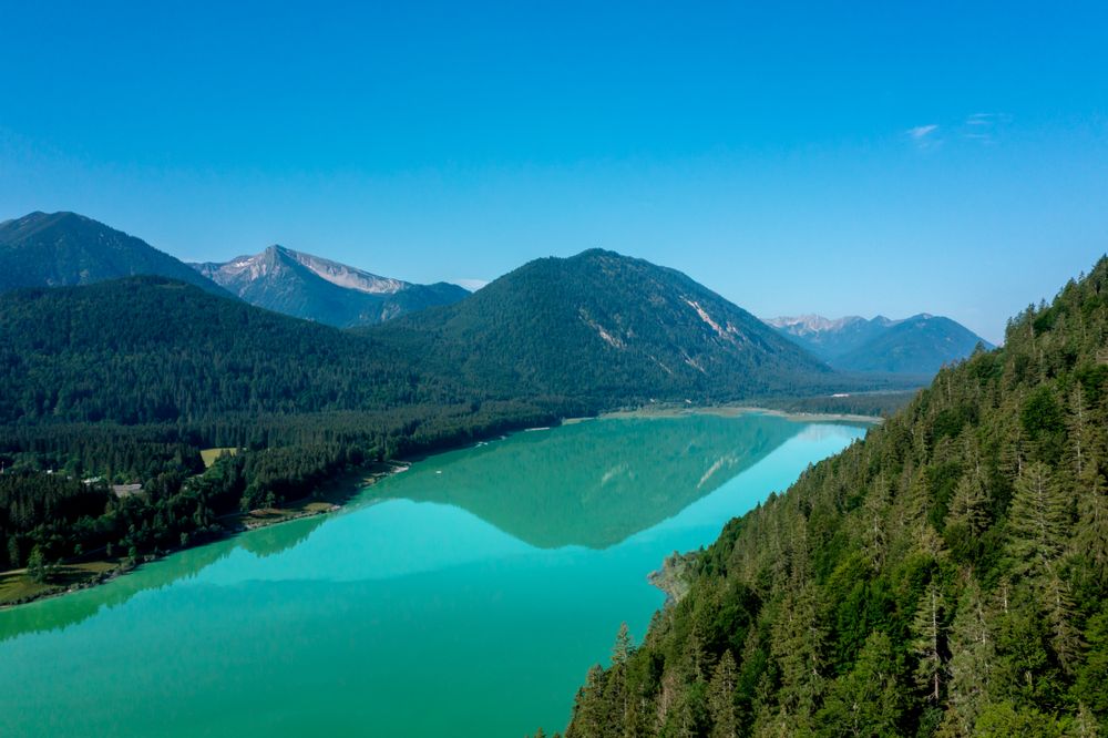 Sunrise aerial view of Lake Sylvenstein surrounded by Bavarian Alps