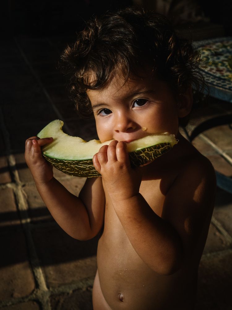 little girl eating melon
