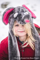 Young girl in red coat wearing rat hat covering the head 0Pmml5