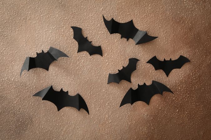 Halloween paper bats on brown wall background