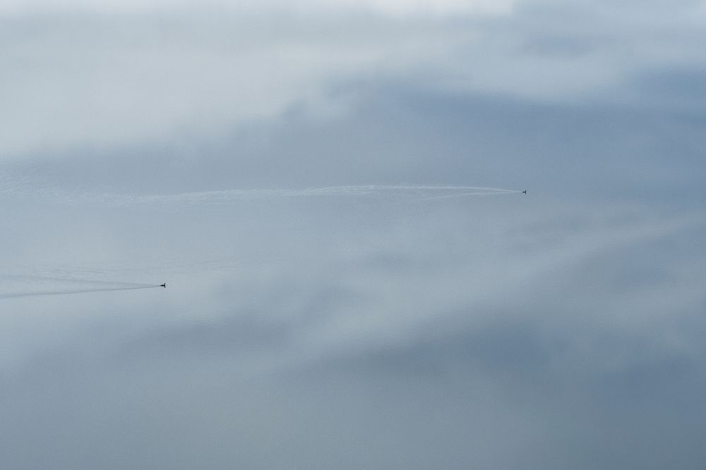 Small speedy aircraft flying in cloudy sky