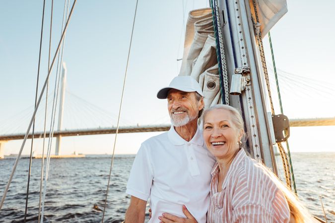 Loving older couple on a sail boat together at dusk