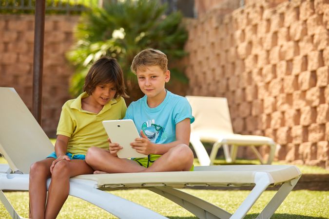 Boys using tablet in garden