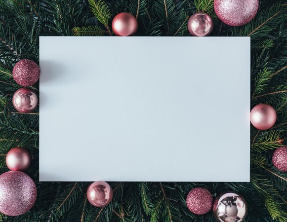 Pine tree branches with pink baubles and paper center