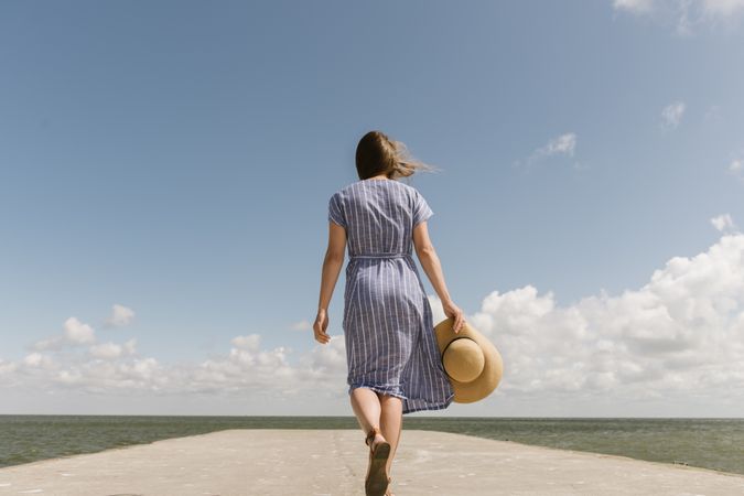 Young woman on sea wharf