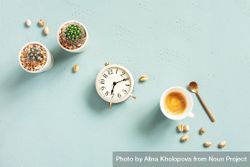 Espresso with spoon, with succulents and clock on baby blue background 0K2yZb