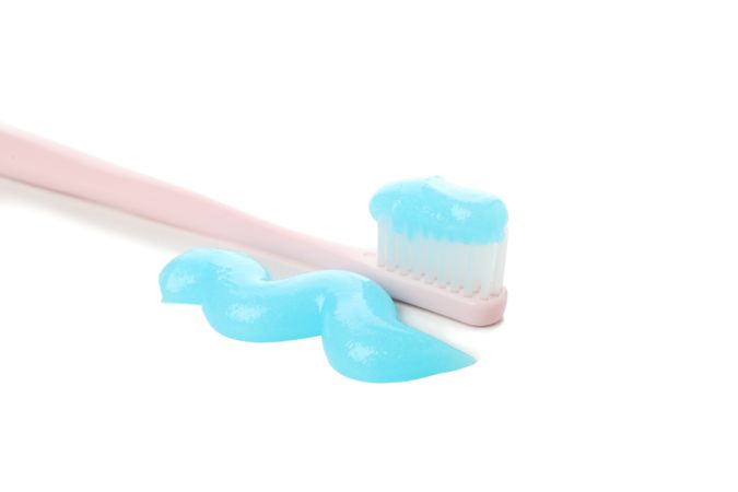 Toothbrush with toothpaste isolated on light background