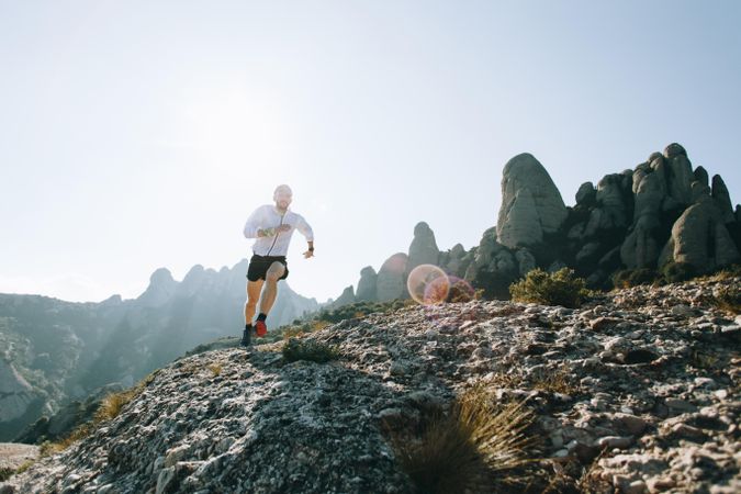 Man trail running on a sunny day