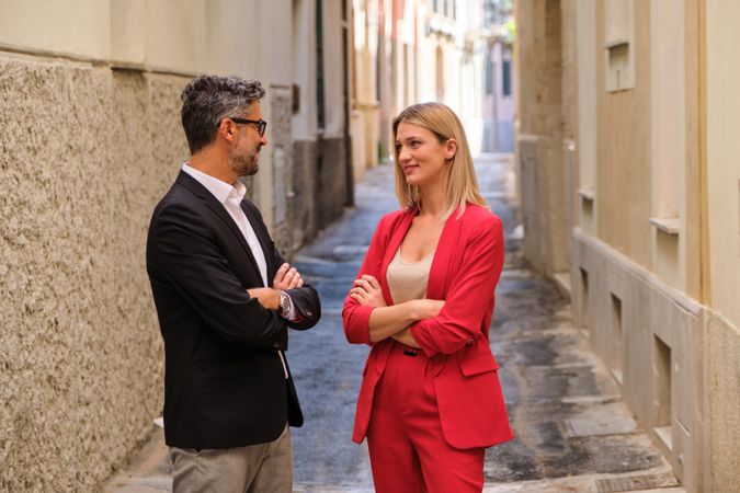 Happy elegant couple standing on street