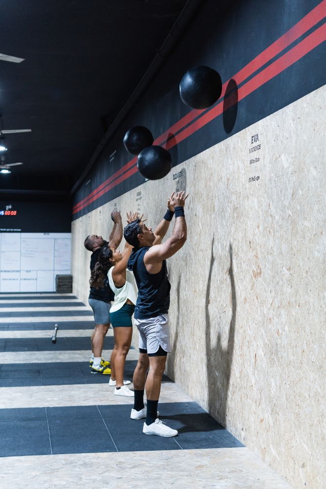 Hispanic sportspeople training with medical balls