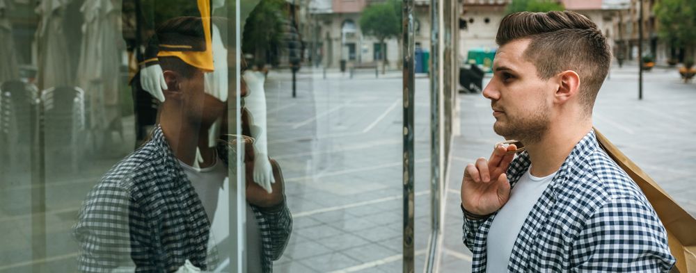 Man looking at the showcase of a store