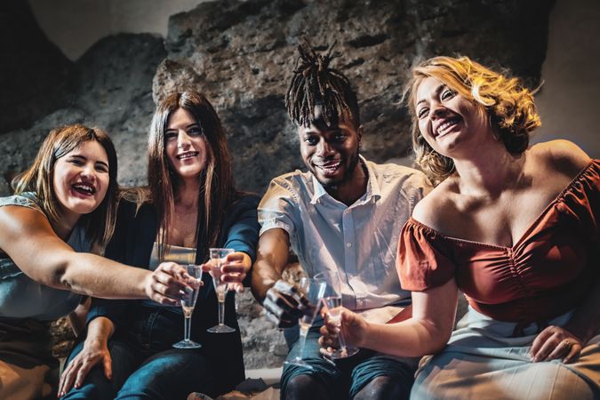 Happy group of multi-ethnic people having a party in the resort's spa cave