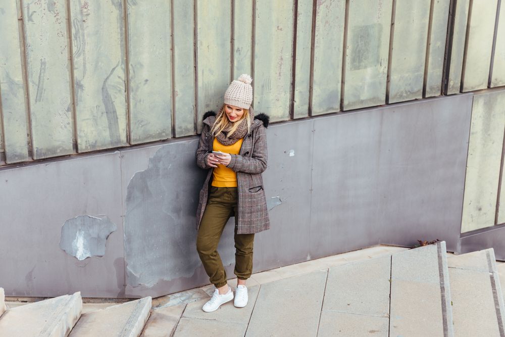 Portrait of blonde woman writing on her phone