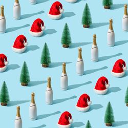 Christmas pattern made with Christmas tree and Santa Claus hat and champagne