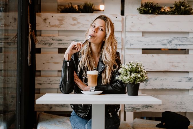 Woman drinking coffee from a glass
