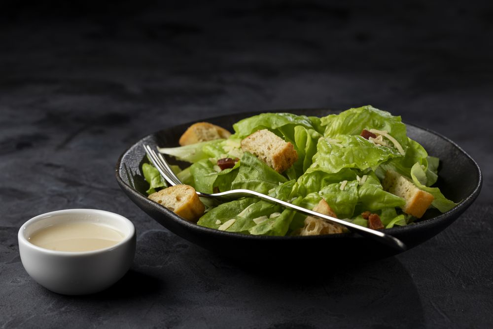 Caesar salad with croutons and bacon.