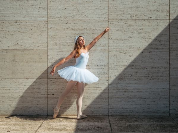 Ballerina doing ballet posing in classroom