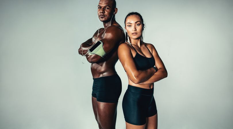 Beautiful athletic couple on grey background