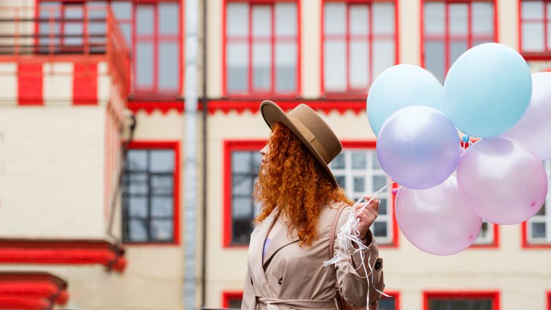 Woman in streets with balloons