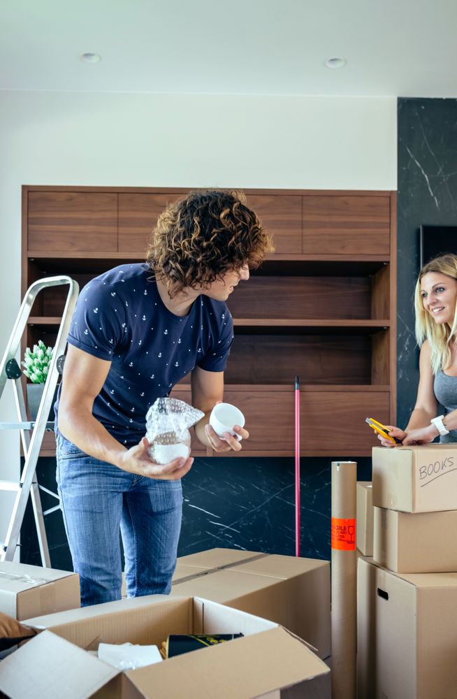 Couple unpacking moving boxes