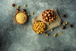 Bowls of whole blanched and unblanched hazelnuts