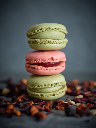 Delicious macaroons near tea leaves