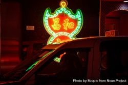 Taxi cab beside lit signage at night in Hong Kong 4N3Zmb