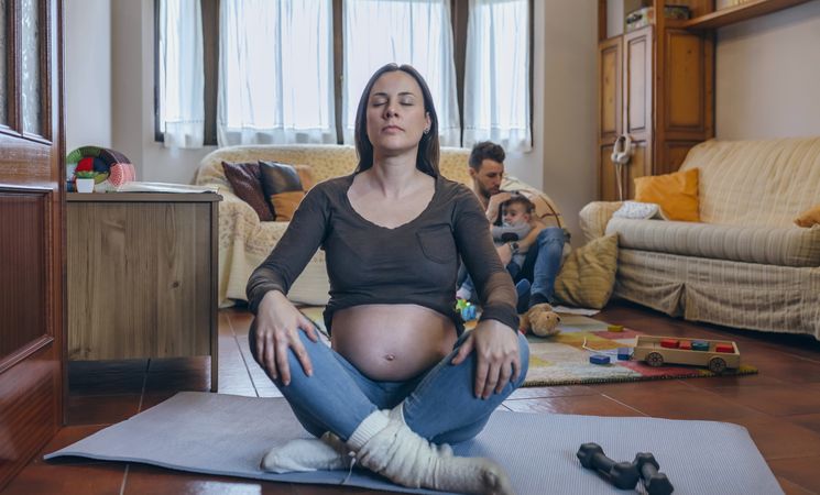 Pregnant woman exercising in the living room