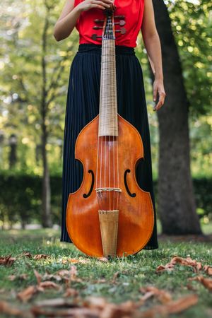 Female musician with her cello outdoors