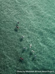 Aerial shot of surfers drifting on the calm open waters 4ZRPn4