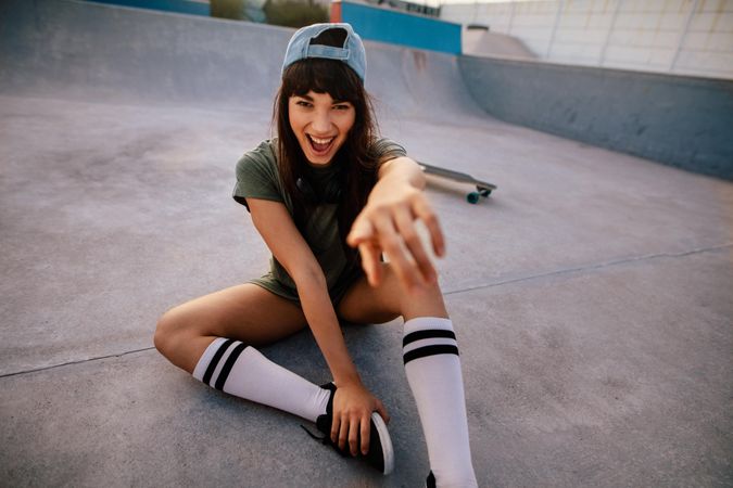 Cheerful woman outdoors at skate park having fun