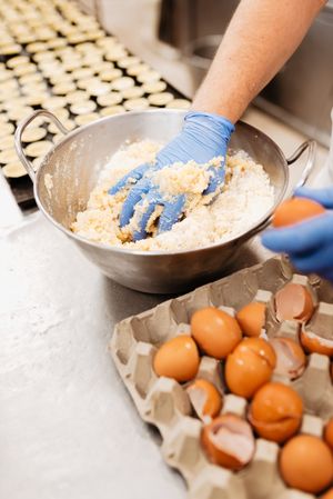 Unrecognizable bakery employee mixing dough